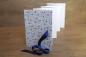 Preview: Leporello open, accordion, light photo cardboard, cover with decorative paper and blue flowers, blue satin bow